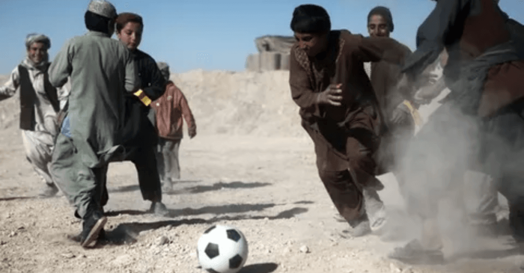 An image of Locals Play Football